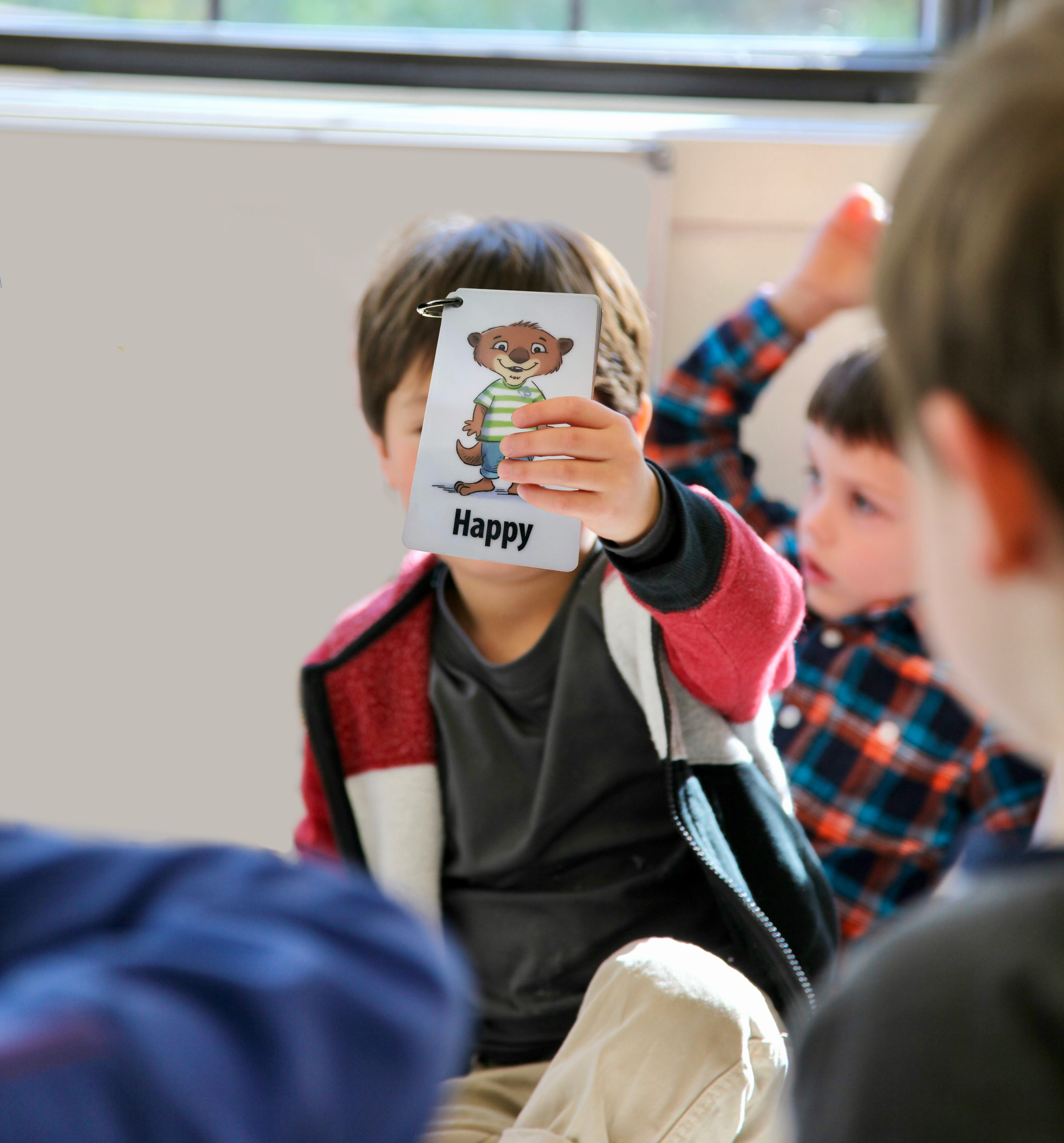 boy-holding-our-emotions-cards - Copy