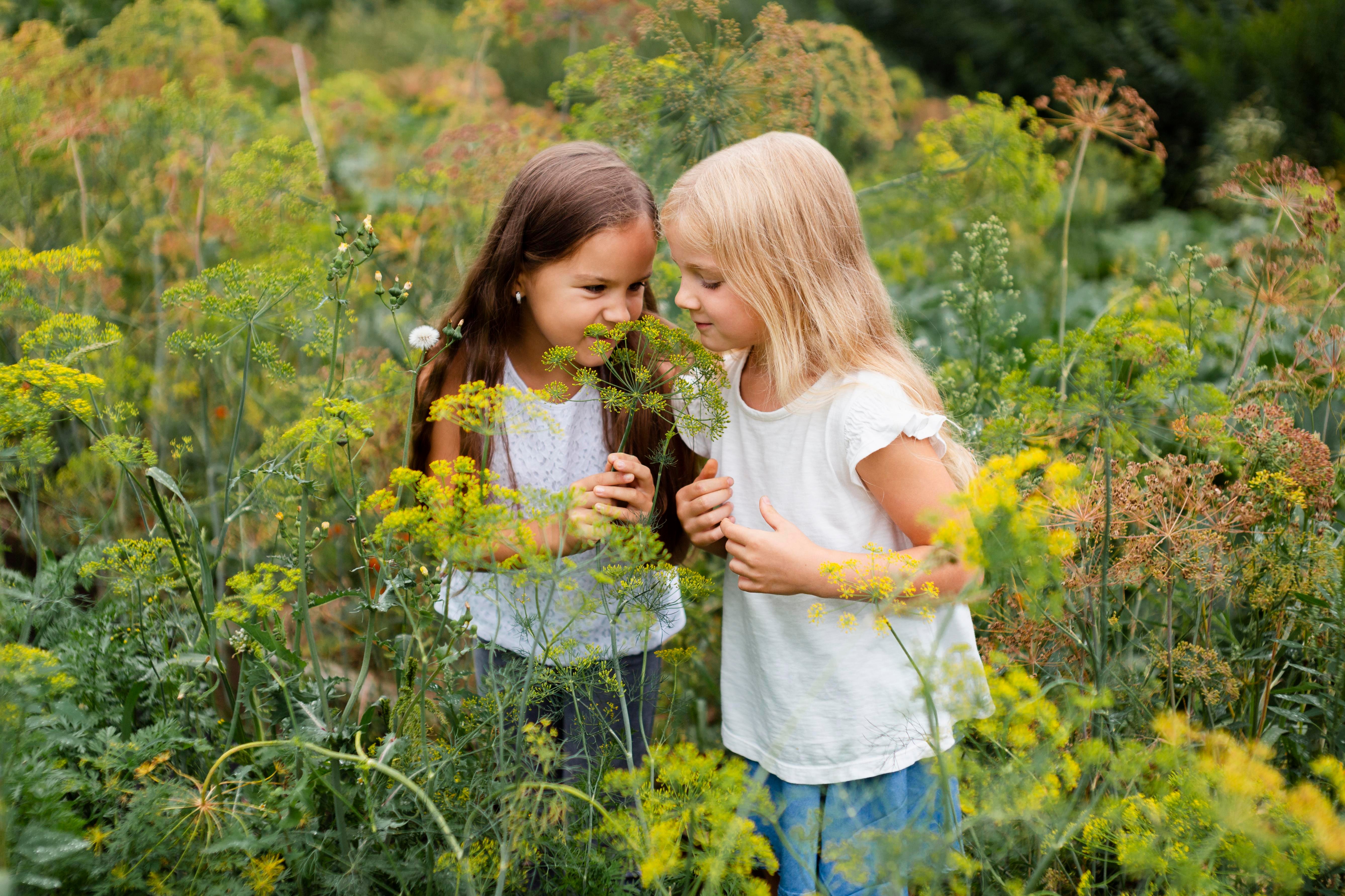 medium-shot-girls-smelling-plant